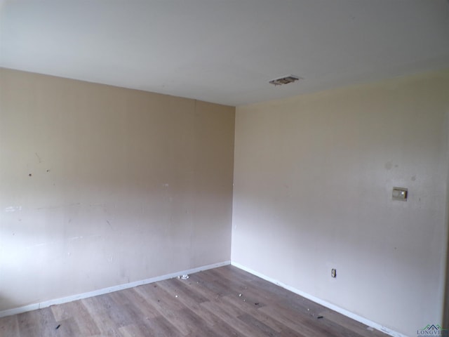 empty room with wood-type flooring