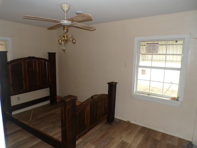 bedroom with ceiling fan and wood-type flooring