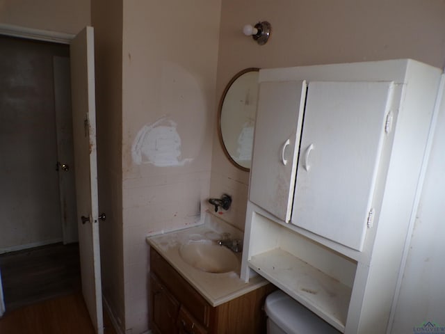 bathroom featuring vanity and toilet