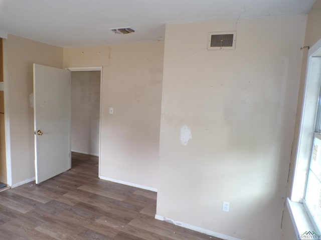 unfurnished room with hardwood / wood-style flooring