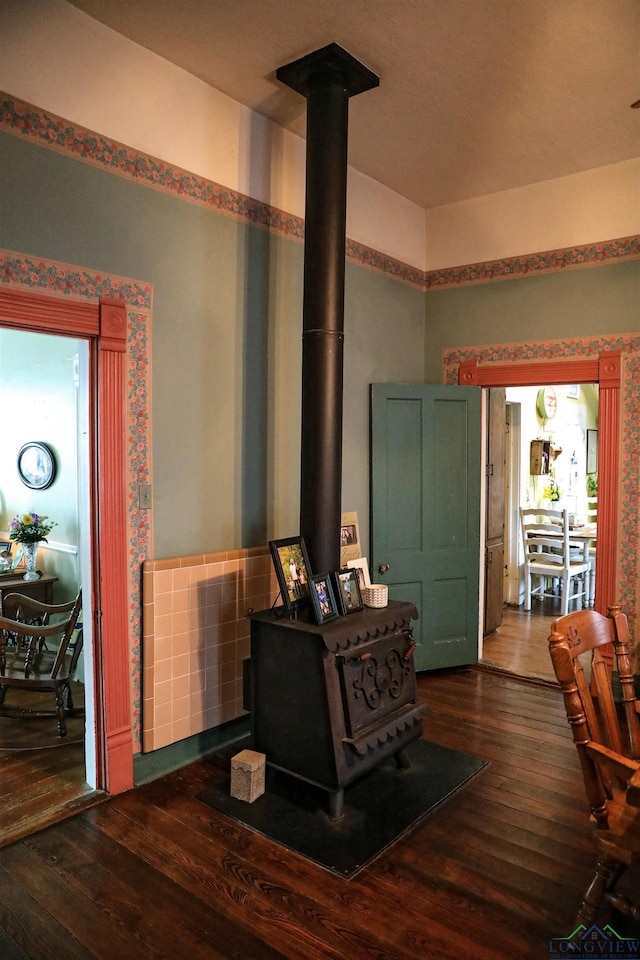 interior space with dark hardwood / wood-style flooring and a wood stove