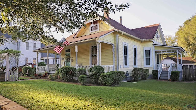 view of front of property with a porch and a front lawn