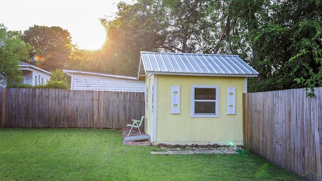 view of outbuilding featuring a lawn