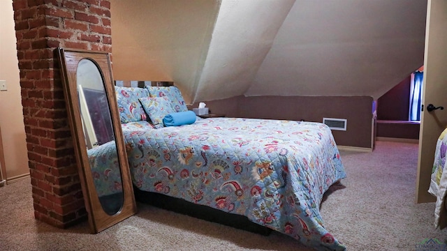 bedroom with carpet floors and lofted ceiling