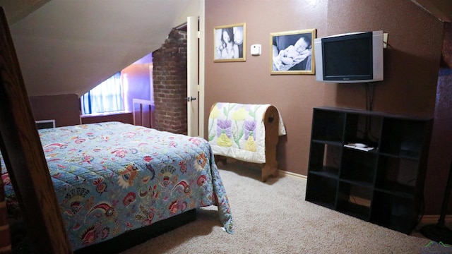 bedroom with carpet floors and vaulted ceiling