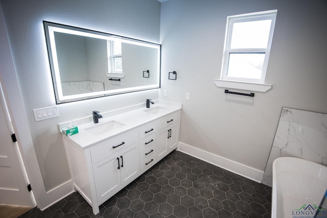 bathroom featuring vanity, a healthy amount of sunlight, and a washtub