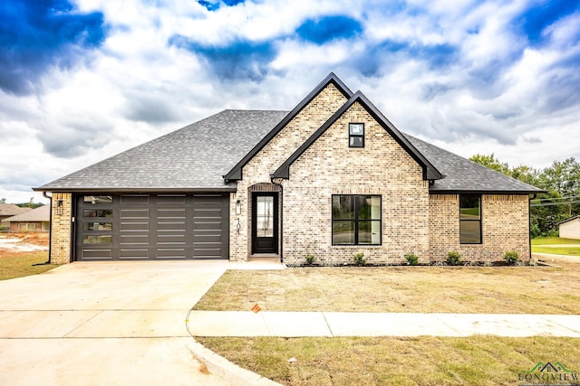 view of front facade with a front yard and a garage