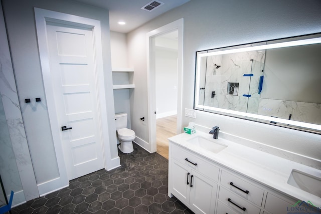 bathroom featuring vanity, toilet, and walk in shower