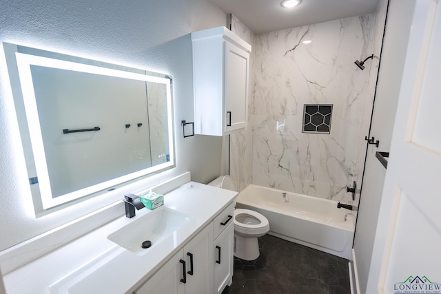 full bathroom featuring tile patterned flooring, vanity, toilet, and tiled shower / bath combo