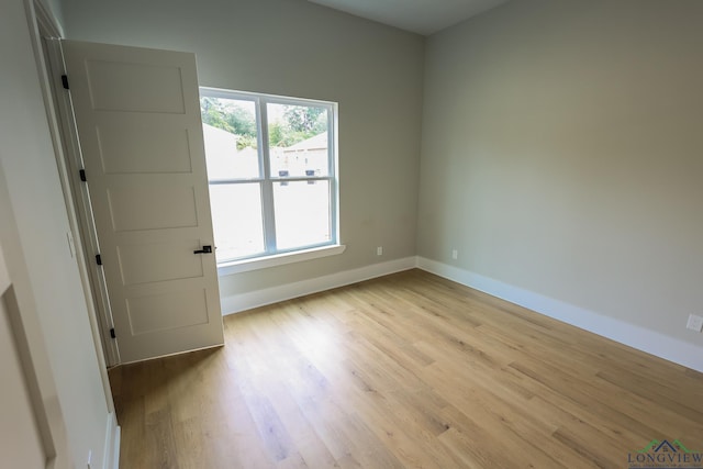 spare room featuring light hardwood / wood-style floors