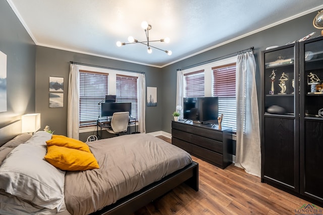 bedroom featuring hardwood / wood-style flooring, a notable chandelier, and crown molding