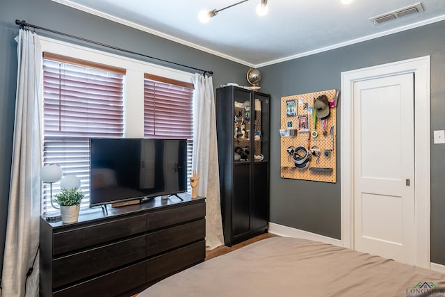 bedroom featuring multiple windows and crown molding