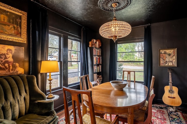 dining space with an inviting chandelier