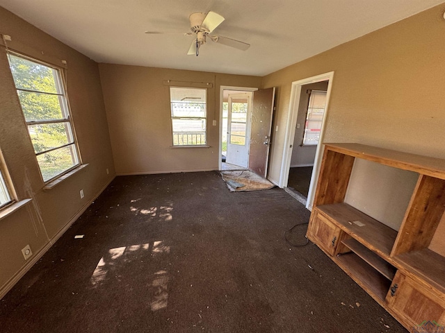 unfurnished living room featuring ceiling fan