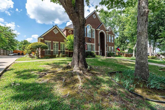 1303 Lesley, Longview, TX 75604 - view of front of home with a front lawn, fence, and brick siding