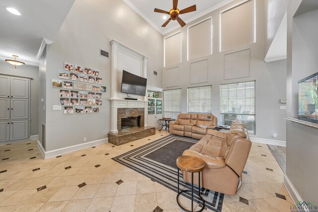1303 Lesley, Longview, TX 75604 - living room featuring light tile patterned flooring, crown molding, a ceiling fan, visible vents, and a towering ceiling