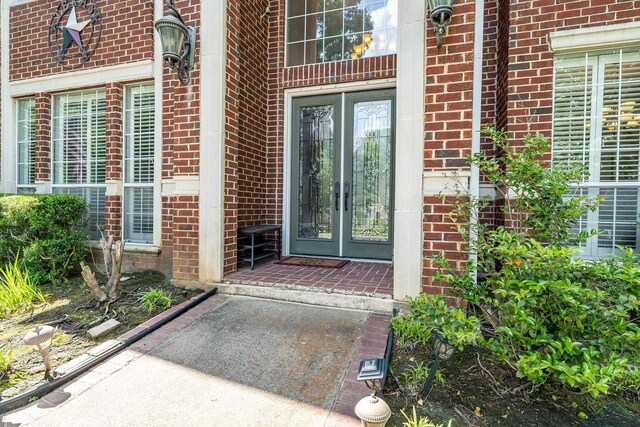 1303 Lesley, Longview, TX 75604 - doorway to property featuring brick siding and french doors