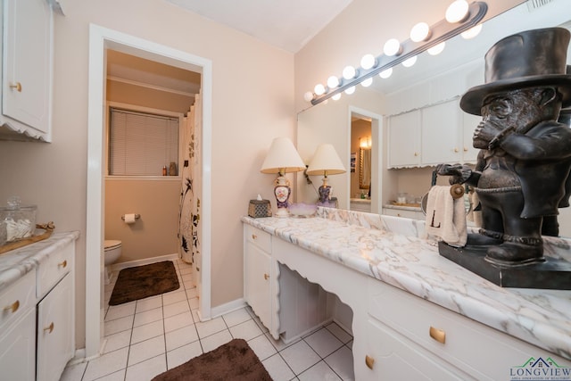 bathroom with vanity, toilet, and tile patterned flooring