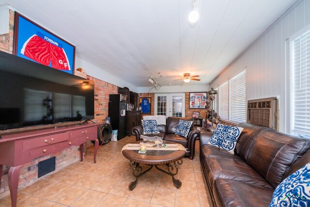 living room featuring light tile patterned floors, ceiling fan, and french doors