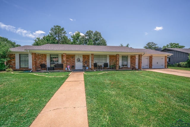 ranch-style house featuring a garage, covered porch, and a front lawn