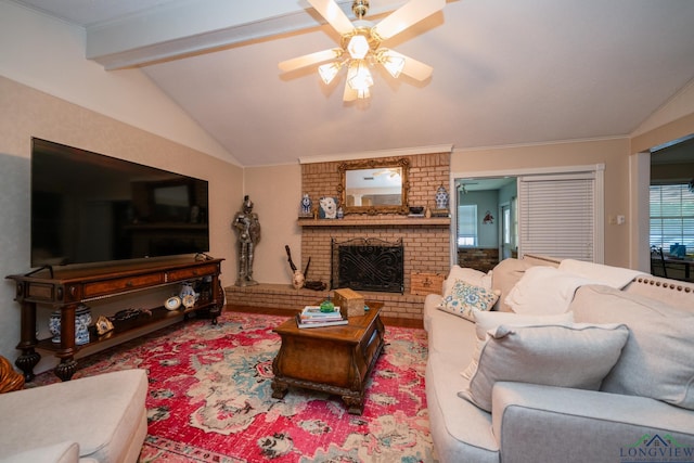 living room with crown molding, ceiling fan, a brick fireplace, and vaulted ceiling with beams