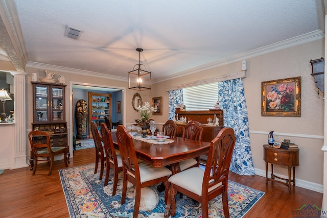 dining space with dark hardwood / wood-style flooring and crown molding