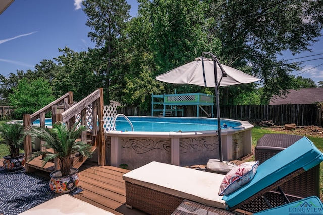 view of swimming pool featuring a wooden deck