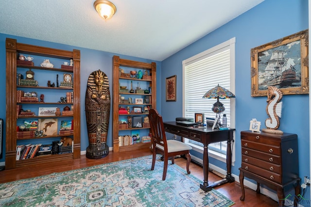 office area with hardwood / wood-style floors and a textured ceiling