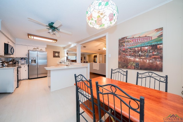 dining space with ceiling fan and ornamental molding