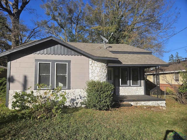 view of side of property with a yard