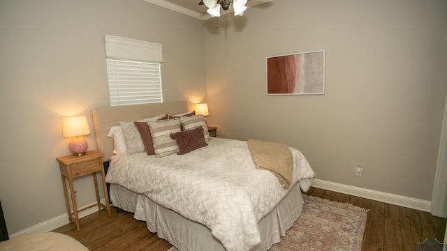 bedroom with ceiling fan, wood-type flooring, and ornamental molding