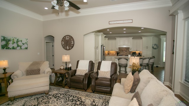 living room with crown molding, hardwood / wood-style floors, and ceiling fan