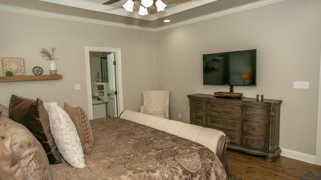 bedroom featuring ensuite bathroom, ornamental molding, a raised ceiling, ceiling fan, and hardwood / wood-style floors