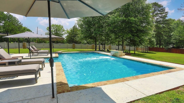 view of swimming pool with a lawn, pool water feature, and a patio