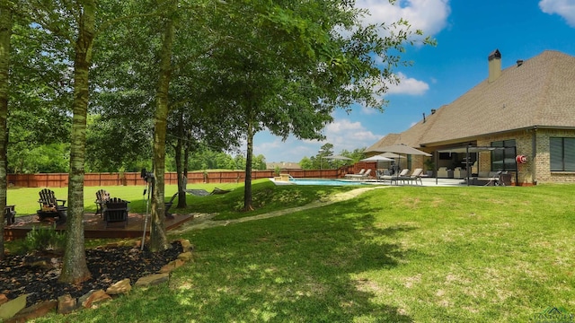 view of yard with a fenced in pool and a patio