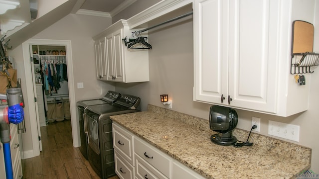 laundry room with cabinets, independent washer and dryer, dark hardwood / wood-style floors, and ornamental molding