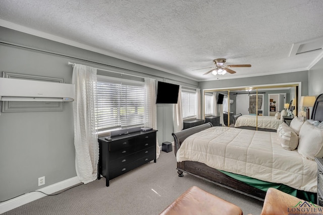 carpeted bedroom with baseboards, attic access, ceiling fan, and a textured ceiling
