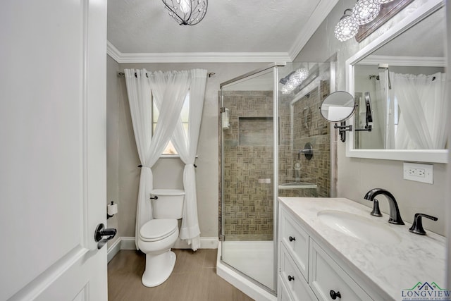 full bath with crown molding, toilet, vanity, a shower stall, and a textured ceiling