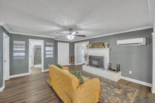 living area featuring a wall mounted air conditioner, crown molding, baseboards, ceiling fan, and wood finished floors