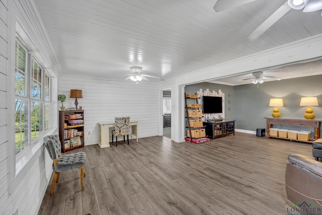 living room with ceiling fan, wood finished floors, and plenty of natural light