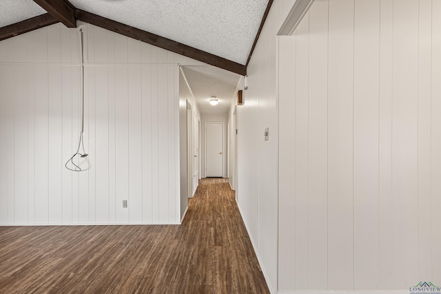 hallway with a textured ceiling, lofted ceiling with beams, and dark wood finished floors