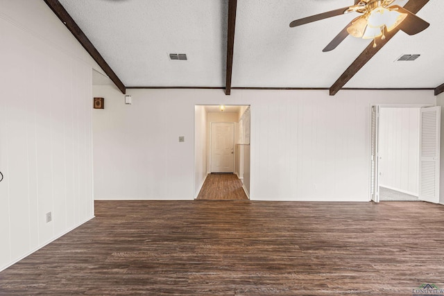 unfurnished living room featuring beamed ceiling, wood finished floors, and visible vents