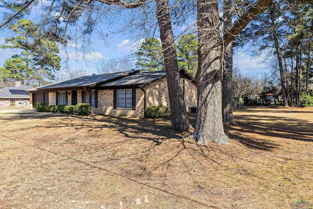 view of front facade featuring a garage, driveway, and brick siding