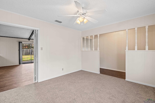 unfurnished room featuring ceiling fan, a textured ceiling, visible vents, and carpet flooring