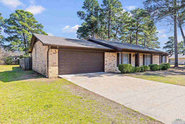 ranch-style house with a garage, driveway, brick siding, and a front yard