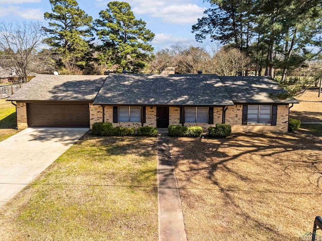 ranch-style house featuring brick siding, roof with shingles, a front yard, a garage, and driveway