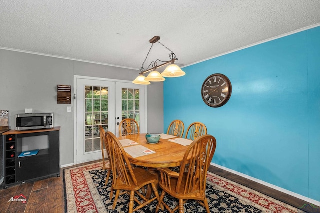 dining area with a textured ceiling, french doors, dark hardwood / wood-style floors, and ornamental molding