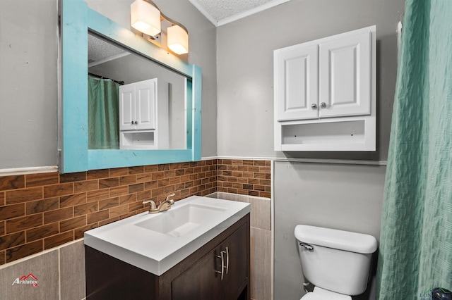 bathroom featuring vanity, a textured ceiling, and toilet