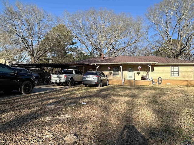 view of vehicle parking with a carport