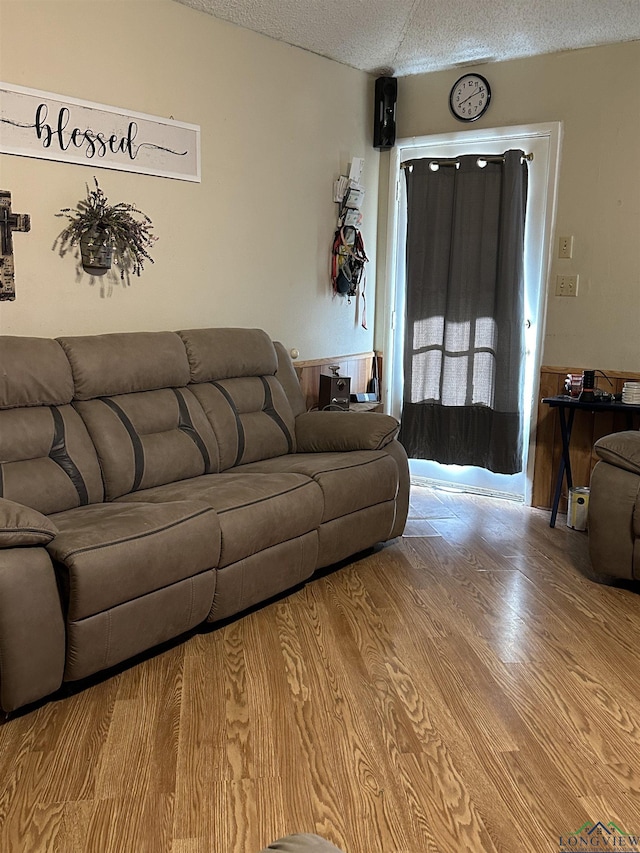18335 Fm 1716 E, Tatum, TX 75691 - living room with lofted ceiling, light hardwood / wood-style flooring, and a textured ceiling